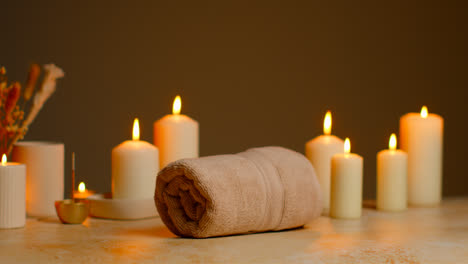 Still-Life-Of-Lit-Candles-With-Dried-Grasses-Incense-Stick-And-Soft-Towels-As-Part-Of-Relaxing-Spa-Day-Decor-8